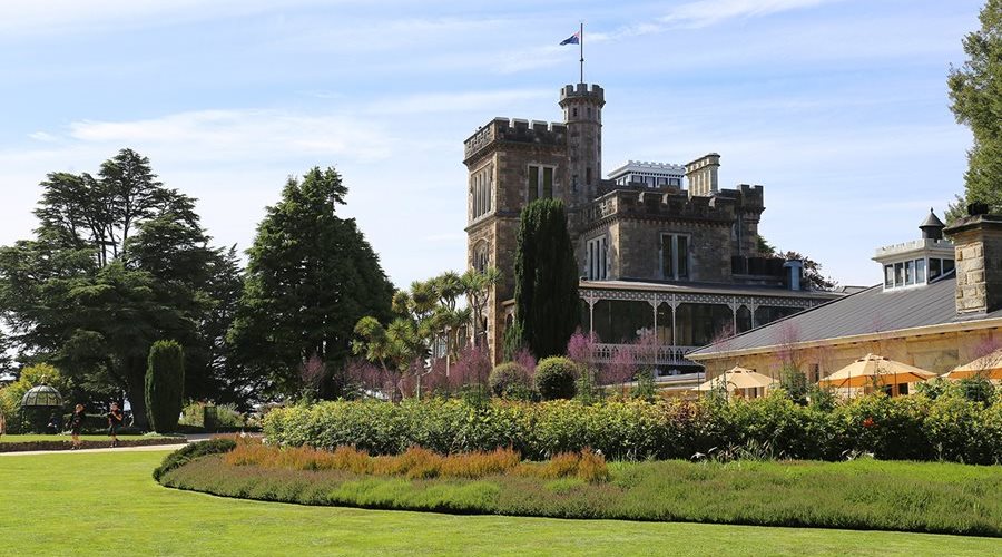 Why do plants seem to flower so late at Larnach Castle?